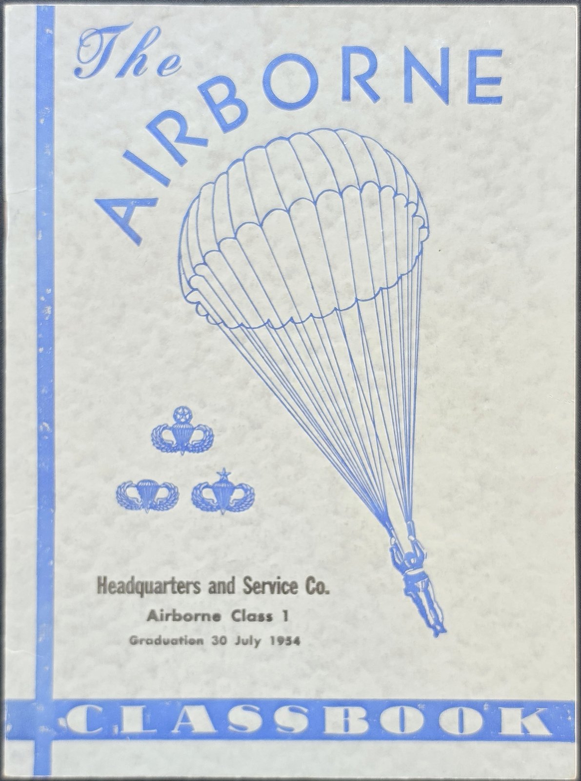 Cover of The Airborne Classbook with a parachutist and three parachutist badges, printed Headquarters and Service Co., Airborne Class 1, Graduation 30 July 1954