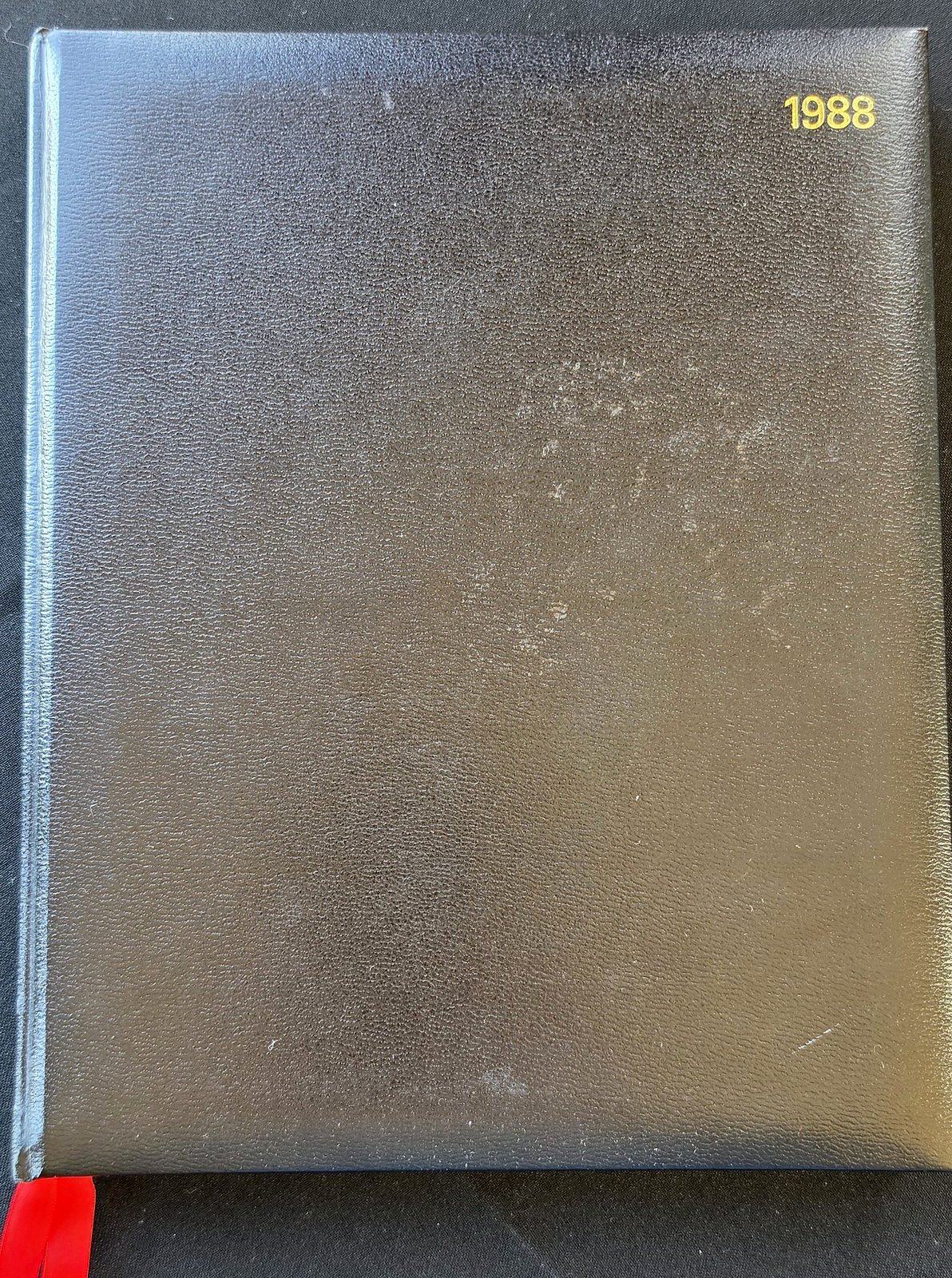 Black leather-look diary cover stamped 1988 in gold at the upper right, with a red ribbon marker