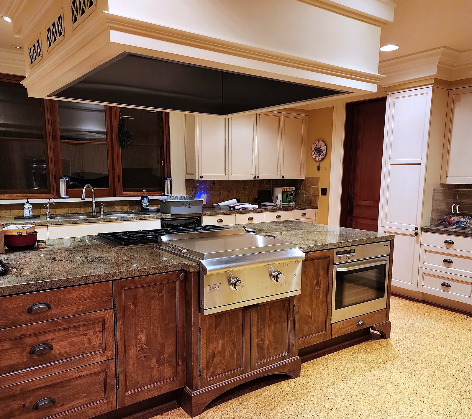 Kitchen with wood cabinetry and range hood